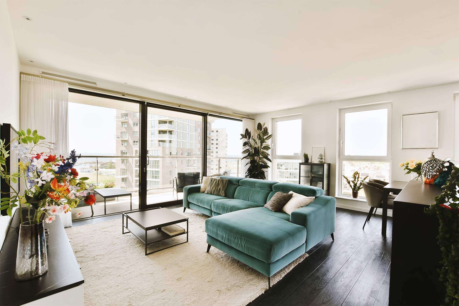 a-living-room-with-a-green-couch-and-large-windows-2025-02-10-11-14-02-Q83UQRM.jpg